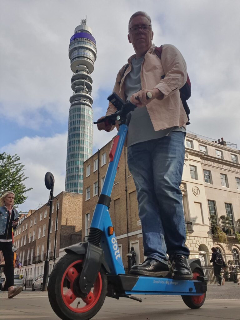 Andy on an e scooter near the BT Tower in London