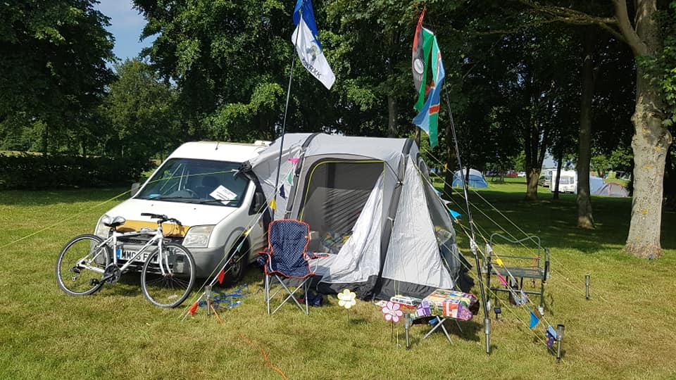 Tentmantent's van, awning, bike and flags at Lincolnshire 2021
